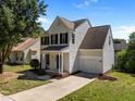 Two-story home featuring an attached garage and a long driveway at 620 Hanska Way, Raleigh, NC 27610