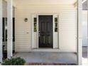 A welcoming covered porch leads to the front door, framed by sidelights at 620 Hanska Way, Raleigh, NC 27610