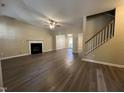 Spacious living room featuring a fireplace, ceiling fan, and hard surface flooring at 620 Hanska Way, Raleigh, NC 27610