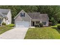View of a one story home featuring a light colored facade, attached garage, and manicured lawn at 633 Prickly Pear Dr, Fuquay Varina, NC 27526