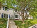 Charming home featuring a patriotic display with an American flag and blue shutters enhancing the curb appeal at 6718 Twin Tree Ct, Raleigh, NC 27613