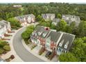Aerial shot of the brick townhomes, lush landscaping, and the #7 Highlands, creating a serene neighborhood at 703 Kirkeenan Cir, Morrisville, NC 27560