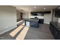 Well-lit kitchen with granite countertops, an island, and dark wood cabinets at 72 Ruskin Dr, Smithfield, NC 27577