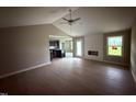 Open living area with light wood floors, ceiling fan, and connecting view into the kitchen at 72 Ruskin Dr, Smithfield, NC 27577