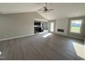 Bright open-concept living room with vaulted ceiling, modern fireplace, and wood-look flooring at 72 Ruskin Dr, Smithfield, NC 27577