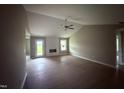 Bright living room featuring high ceilings, ceiling fan, wood-look flooring, and a fireplace at 72 Ruskin Dr, Smithfield, NC 27577