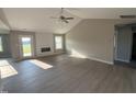 Bright living room features vaulted ceilings, wood floors, and a modern fireplace at 72 Ruskin Dr, Smithfield, NC 27577