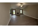 Spacious living room featuring high ceilings, a fireplace, and access to the outdoor patio at 72 Ruskin Dr, Smithfield, NC 27577
