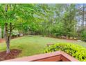 A spacious backyard with lots of greenery, a trampoline and a fire pit at 7321 Clarincarde Ct, Wake Forest, NC 27587