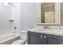 Cozy bathroom featuring a shower-tub, storage vanity and bright lighting at 743 W Holly Springs Rd, Holly Springs, NC 27540