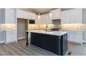 A spacious kitchen with a center island, and stainless steel appliances at 743 W Holly Springs Rd, Holly Springs, NC 27540