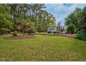 Expansive backyard features a lush green lawn and a storage building at 817 S Creek Dr, Nashville, NC 27856