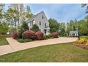 Charming two-story home with lush landscaping, a basketball court, and a storage building at 817 S Creek Dr, Nashville, NC 27856