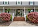 Inviting front porch featuring brick steps and decorative plants at 817 S Creek Dr, Nashville, NC 27856