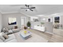 Open concept living room boasts neutral colors, vaulted ceilings and seamless flow to the kitchen at 8201 Rhodes Rd, Apex, NC 27539