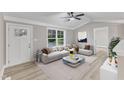 Inviting living room filled with natural light, neutral furnishings, and a stylish rug and flooring at 8201 Rhodes Rd, Apex, NC 27539