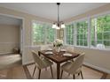 Bright dining room with lots of windows and a chandelier, perfect for entertaining at 928 Broadhaven Dr, Raleigh, NC 27603