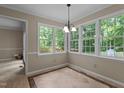 Bright dining room with lots of windows and herringbone floors, perfect for entertaining at 928 Broadhaven Dr, Raleigh, NC 27603