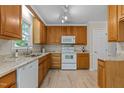 Kitchen with white appliances, tile floors and light wood cabinetry at 928 Broadhaven Dr, Raleigh, NC 27603