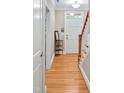 Inviting foyer with gleaming hardwood floors, staircase, and a decorative table at 110 Tressel Way, Durham, NC 27707