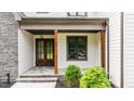 Inviting front entry with double doors, stone accents, and manicured landscaping at 1108 Delilia Ln, Wake Forest, NC 27587