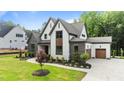 Beautiful exterior of a two-story home with stone and siding, plus landscaped front yard and driveway at 1108 Delilia Ln, Wake Forest, NC 27587