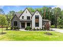 Stunning two-story home featuring stone accents, white siding, and a lush green lawn at 1108 Delilia Ln, Wake Forest, NC 27587