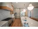 Spacious kitchen with marble countertops, stainless steel appliances, and custom cabinetry provides a modern culinary space at 1108 Delilia Ln, Wake Forest, NC 27587