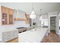Modern kitchen with quartz countertops, stainless steel appliances, and pendant lighting at 1108 Delilia Ln, Wake Forest, NC 27587