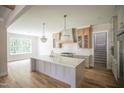 Spacious kitchen with a large island, ample cabinet space, and hardwood floors at 1108 Delilia Ln, Wake Forest, NC 27587