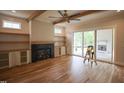 Bright living room with hardwood floors, a modern fireplace, and sliding glass doors to the back at 1108 Delilia Ln, Wake Forest, NC 27587