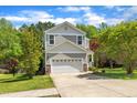 Attractive two-story home showcasing a two-car garage, well-kept lawn, and complementary landscaping at 1198 Shining Water Ln, Creedmoor, NC 27522