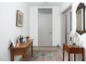 Charming entryway with antique furniture and a colorful rug at 130 Hunt St # 107, Durham, NC 27701