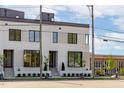 Modern white brick exterior showcasing stylish curb appeal with landscaped walkway at 1302 Chamblee Hill Ct, Raleigh, NC 27608