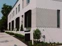 Charming white brick townhome with black-framed windows and professionally landscaped grounds at 1303 Chamblee Hill Ct, Raleigh, NC 27608