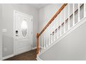 Welcoming entryway featuring wood flooring, a staircase with wooden banister, and a decorative front door at 1307 Torrey Pines Ct, Mebane, NC 27302