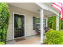 Cozy front porch with seating, a decorative door, and well-maintained plants at 1307 Torrey Pines Ct, Mebane, NC 27302