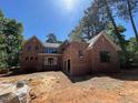 Image showing the exterior of a charming brick home surrounded by lush trees at 1500 Ridge Rd, Raleigh, NC 27607