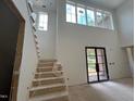Interior view of the entry foyer, staircase and large picture window overlooking the front of the home at 1500 Ridge Rd, Raleigh, NC 27607