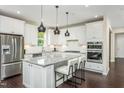 Well-equipped kitchen with granite countertops, white cabinetry, and a center island with seating at 1606 Garden Park Cir, Fuquay Varina, NC 27526