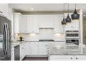 Contemporary kitchen featuring granite countertops, stainless steel appliances, and sleek cabinetry at 1606 Garden Park Cir, Fuquay Varina, NC 27526