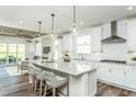 Bright and airy kitchen featuring a large island, stainless steel appliances, and ample counter space at 1614 Garden Park Cir, Fuquay Varina, NC 27526