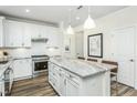 Well-equipped kitchen featuring granite countertops, subway tile backsplash, a center island, and stainless appliances at 1622 Garden Park Cir, Fuquay Varina, NC 27526
