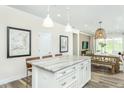 Open-concept kitchen with an island, barstool seating, and a view of the dining and living areas at 1622 Garden Park Cir, Fuquay Varina, NC 27526