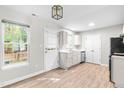 Open eat-in kitchen showcasing laminate floors, bright windows, and stainless appliances at 1628 Briarmont Court Ct, Raleigh, NC 27610