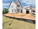 New two-story home featuring a garage, large windows, and situated on a lot during the construction phase at 17 Spring Crest Dr # 68, Angier, NC 27501