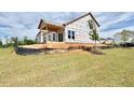 New two-story home featuring a garage, large windows, and situated on a lot during the construction phase at 17 Spring Crest Dr # 68, Angier, NC 27501