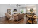 Cozy living room with fireplace, ceiling fan, lots of seating, and an open floorplan at 1800 Tarbert Dr, Cary, NC 27511