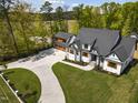 Stunning aerial view of a home with a spacious driveway and a well-manicured lawn at 1903 Edgerton Dr, Durham, NC 27703