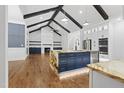 Spacious living room featuring wood floors, a fireplace, and an island with bar seating at 1903 Edgerton Dr, Durham, NC 27703